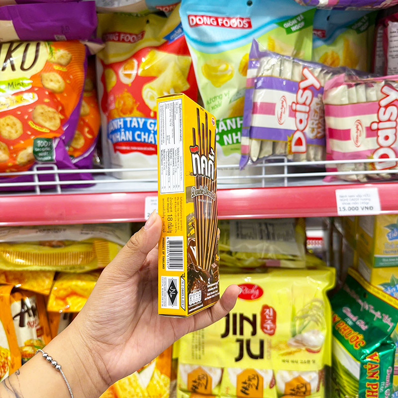 Cạnh hộp thể hiện khối lượng tịnh 18 g và thông tin quy cách