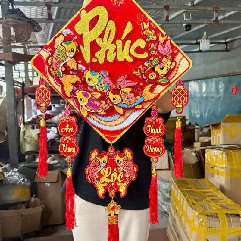 Cận cảnh mẫu chữ Phúc với cụm tua rua đỏ và chi tiết treo trang trí
